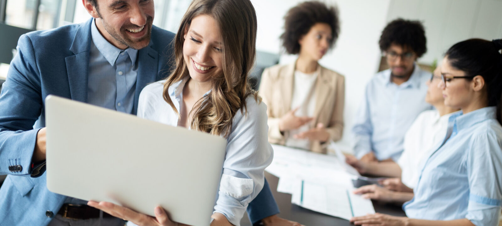 Happy business colleagues modern office working together web